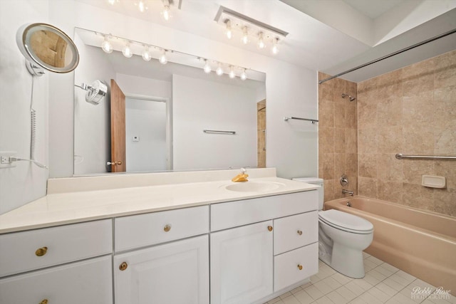 full bathroom with tile patterned flooring, vanity, tiled shower / bath combo, and toilet