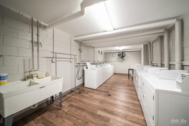 washroom featuring dark hardwood / wood-style flooring, sink, and washer and clothes dryer