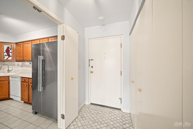 kitchen featuring dishwasher, sink, and high end refrigerator