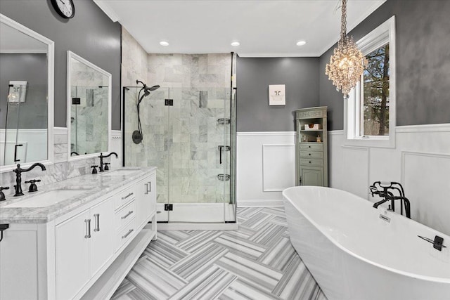 bathroom featuring crown molding, vanity, and shower with separate bathtub