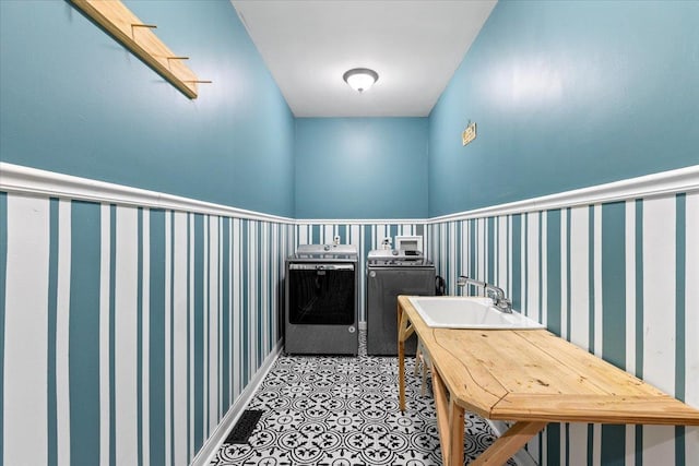 laundry room with separate washer and dryer and sink