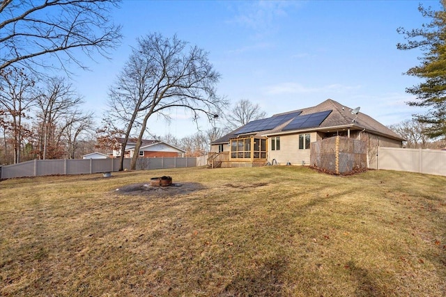 view of yard with a fire pit and a sunroom