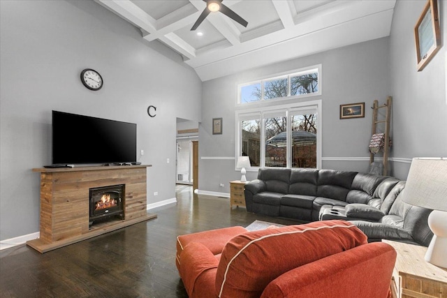 living room featuring coffered ceiling, ceiling fan, dark hardwood / wood-style flooring, beamed ceiling, and a towering ceiling