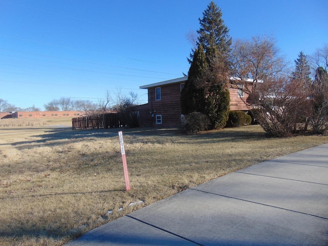 view of side of property with a lawn