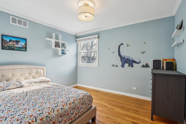 bedroom featuring hardwood / wood-style floors and ornamental molding