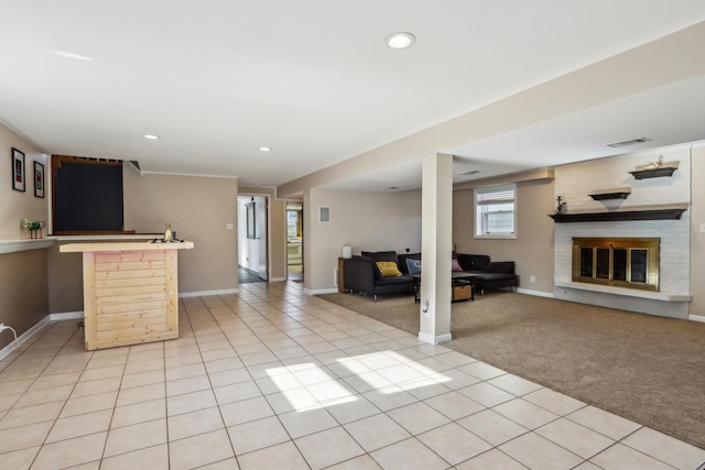 unfurnished living room with a brick fireplace and light carpet