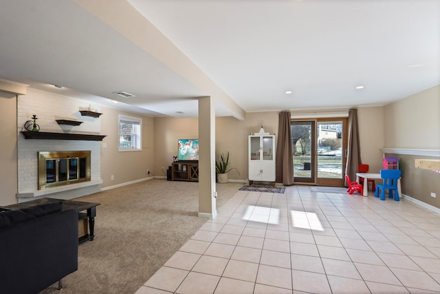 interior space featuring a brick fireplace and light tile patterned flooring