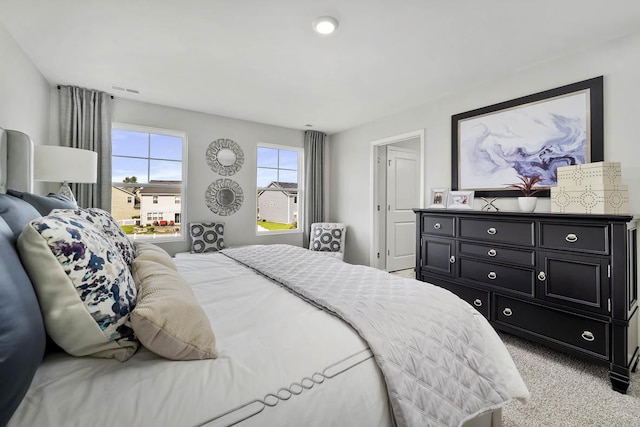 bedroom featuring light carpet