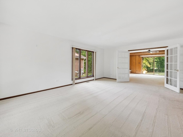 carpeted empty room with french doors