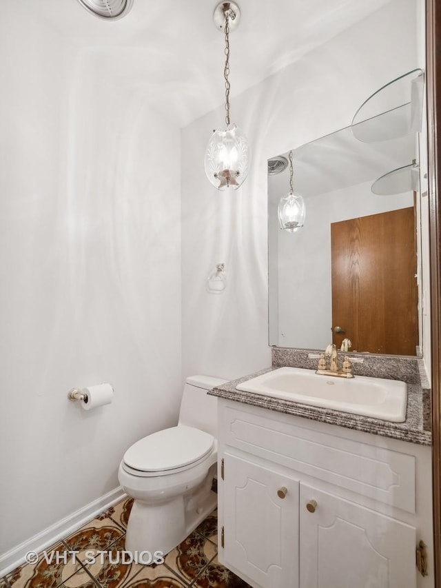 bathroom with toilet and vanity