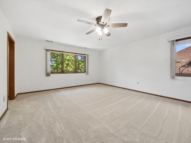 unfurnished room with light carpet and ceiling fan