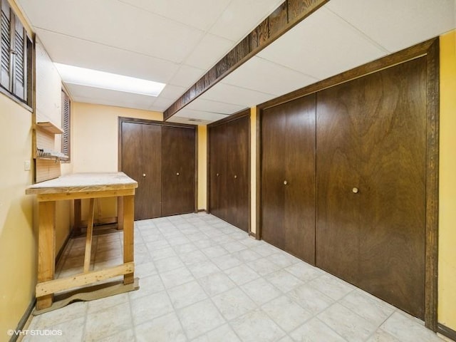 basement featuring a drop ceiling