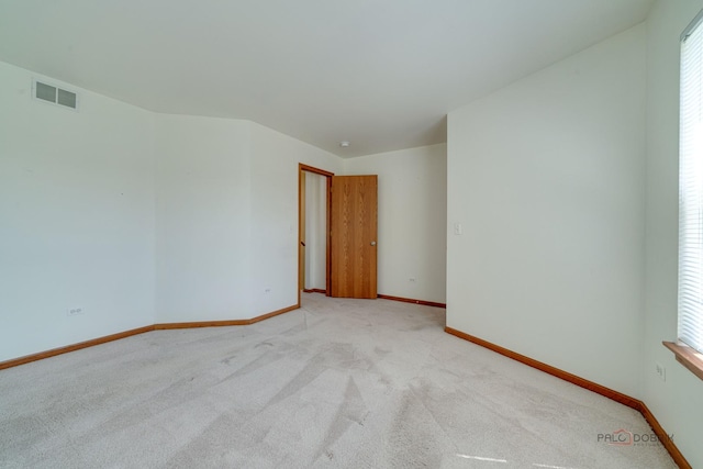 carpeted spare room with a wealth of natural light