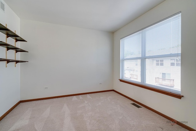 spare room featuring light colored carpet