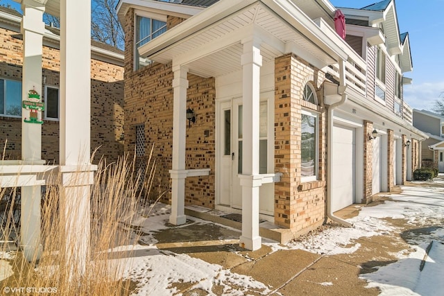 view of snowy exterior with a garage