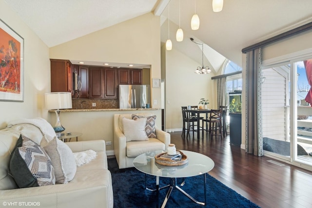 living room featuring vaulted ceiling, a chandelier, and dark hardwood / wood-style flooring