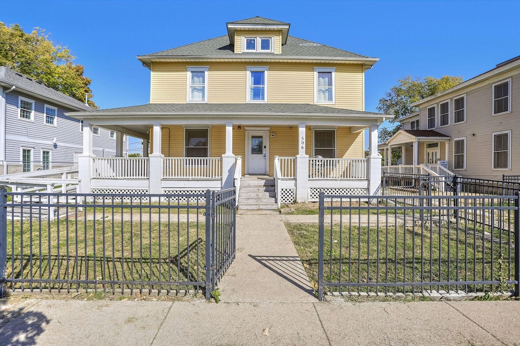 506 E Church St, Champaign, IL 61820 - view of front facade with covered porch and a front lawn