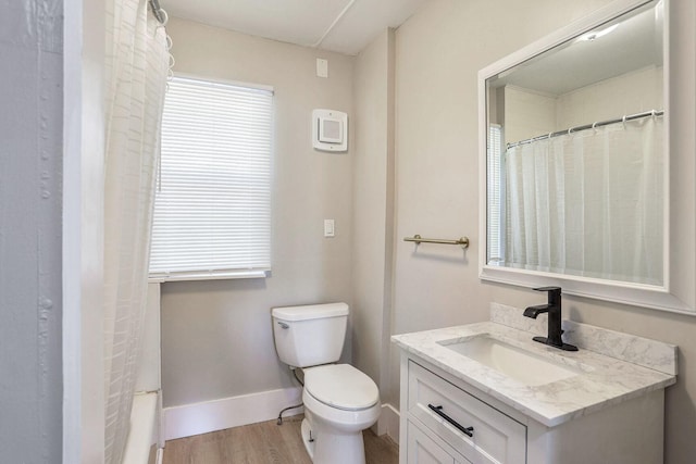 bathroom with hardwood / wood-style flooring, vanity, and toilet