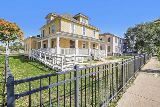 view of front facade with covered porch and a front lawn