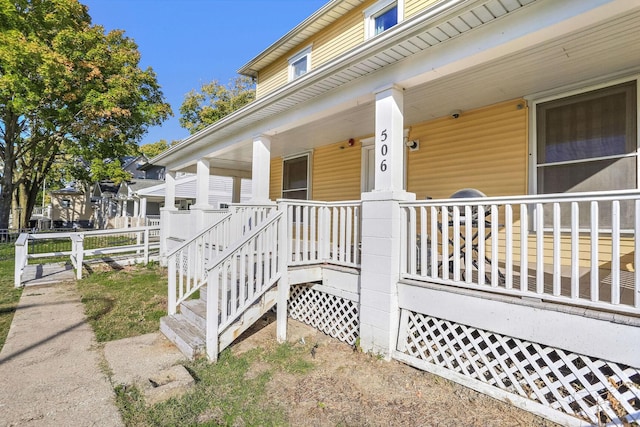 view of exterior entry with covered porch