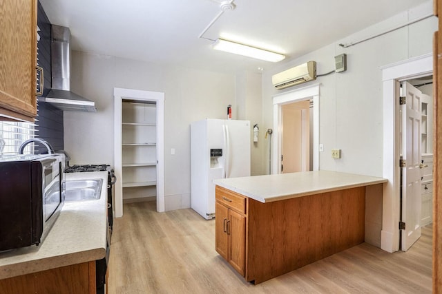 kitchen with a wall mounted air conditioner, white refrigerator with ice dispenser, light hardwood / wood-style floors, kitchen peninsula, and wall chimney range hood