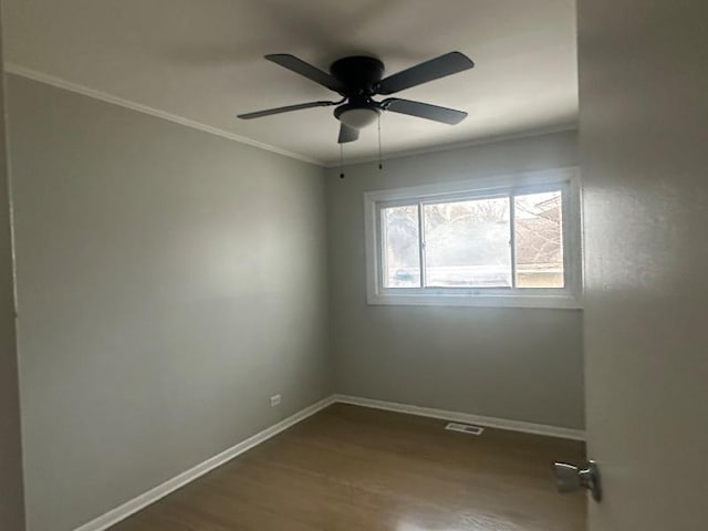 empty room with crown molding, ceiling fan, and hardwood / wood-style floors