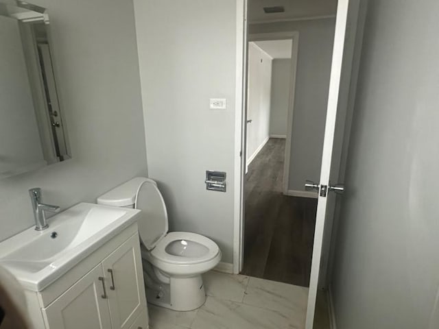 175 Westwood Dr, Park Forest, IL 60466 - bathroom featuring toilet, vanity, baseboards, and marble look tile flooring