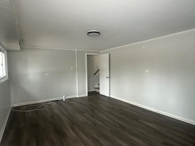 unfurnished room with dark hardwood / wood-style flooring