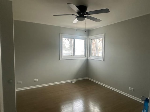 unfurnished room with dark hardwood / wood-style flooring and ceiling fan