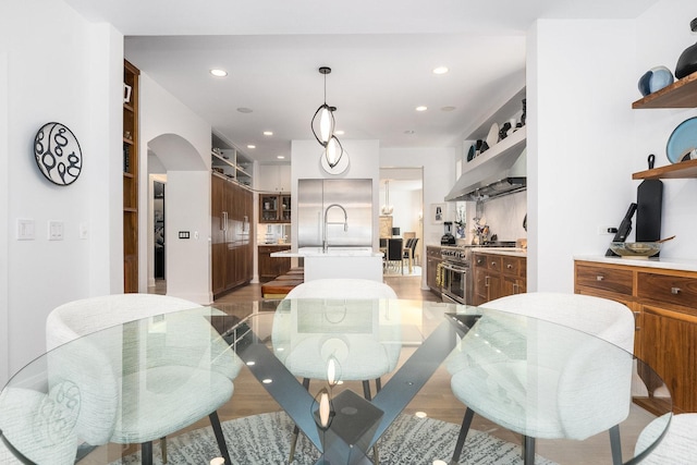 dining area featuring sink and light hardwood / wood-style flooring