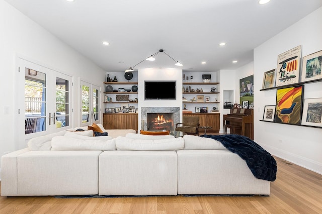 living room featuring light wood-type flooring and french doors