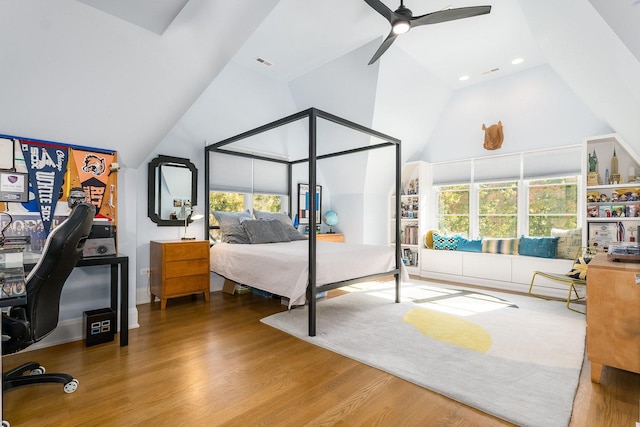 bedroom with multiple windows, hardwood / wood-style flooring, high vaulted ceiling, and ceiling fan