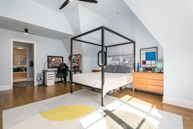 bedroom with hardwood / wood-style flooring, vaulted ceiling, and ceiling fan