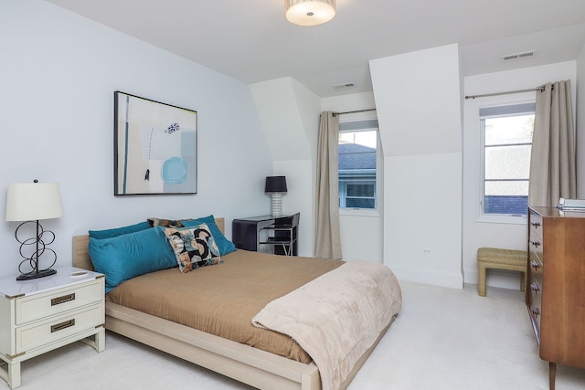 carpeted bedroom featuring multiple windows