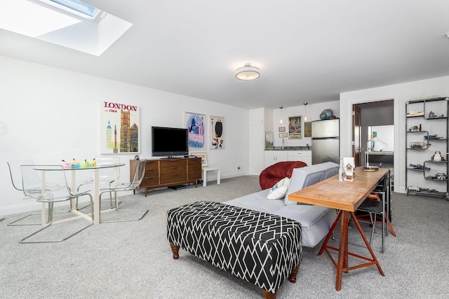 dining space with carpet and a skylight