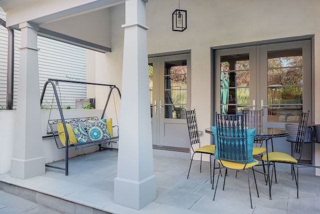 view of exterior entry featuring a patio area and french doors