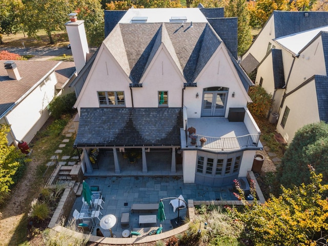 back of house featuring a patio area, french doors, and a balcony