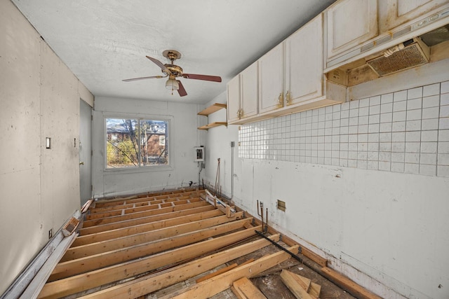 interior space with ceiling fan