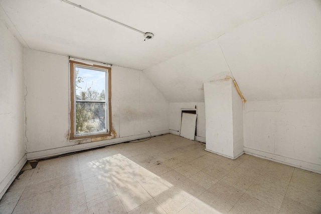 additional living space featuring vaulted ceiling