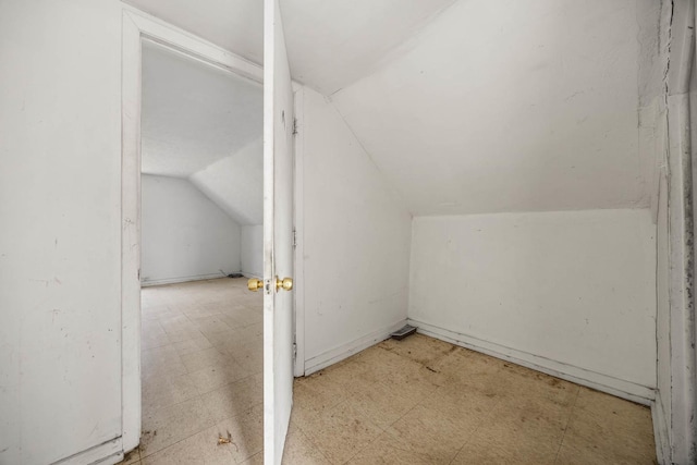 additional living space featuring vaulted ceiling