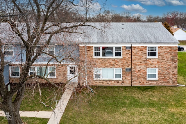 rear view of house with a yard