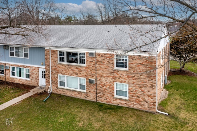 rear view of property with a yard