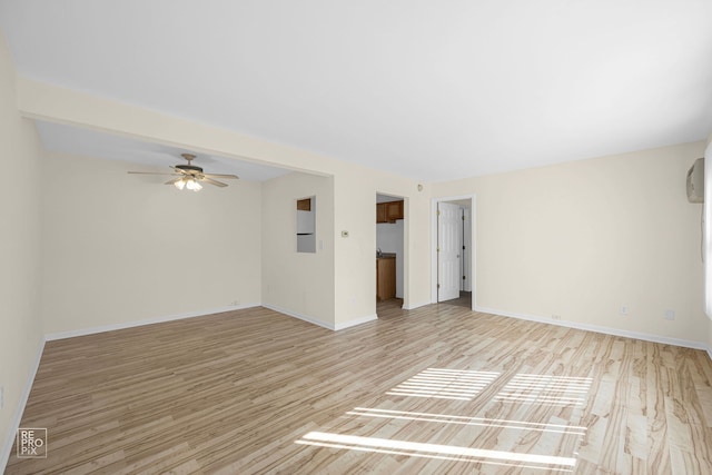 empty room with light hardwood / wood-style floors and ceiling fan