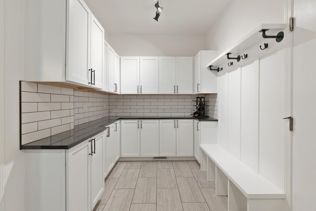 kitchen featuring decorative backsplash and white cabinets