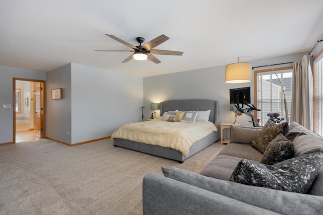 carpeted bedroom featuring connected bathroom and ceiling fan