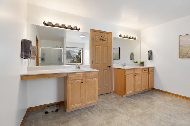 bathroom with vanity and a shower with shower door