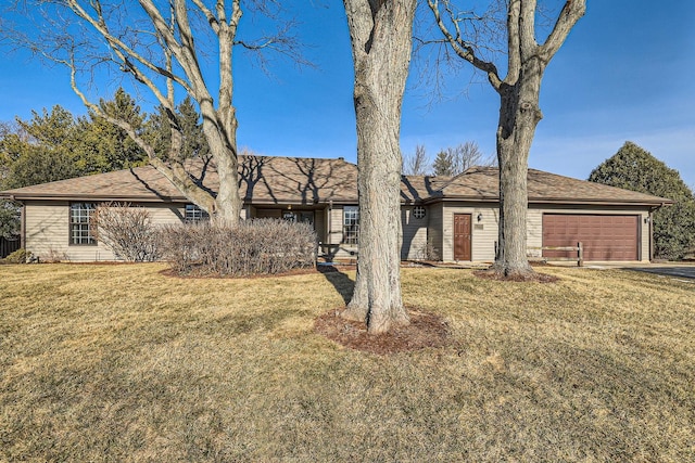 single story home featuring a garage and a front lawn