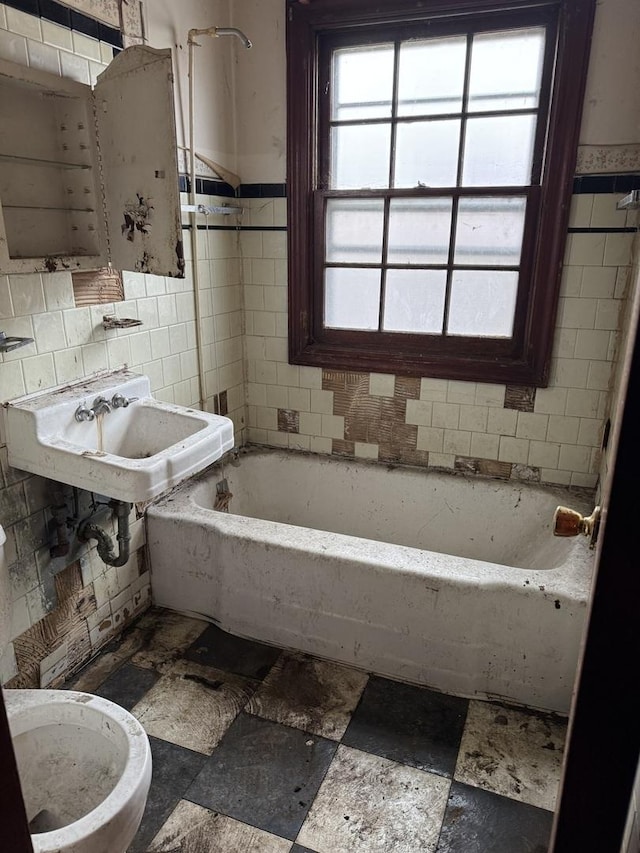 full bathroom with sink, shower / bath combination, toilet, and tile walls