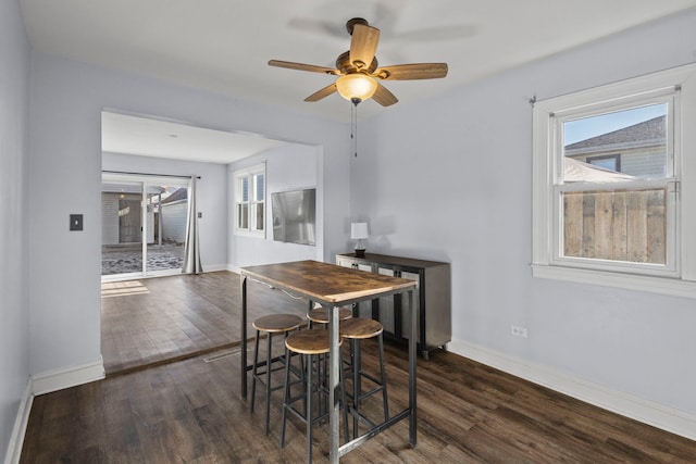 dining space featuring ceiling fan, plenty of natural light, and dark hardwood / wood-style floors