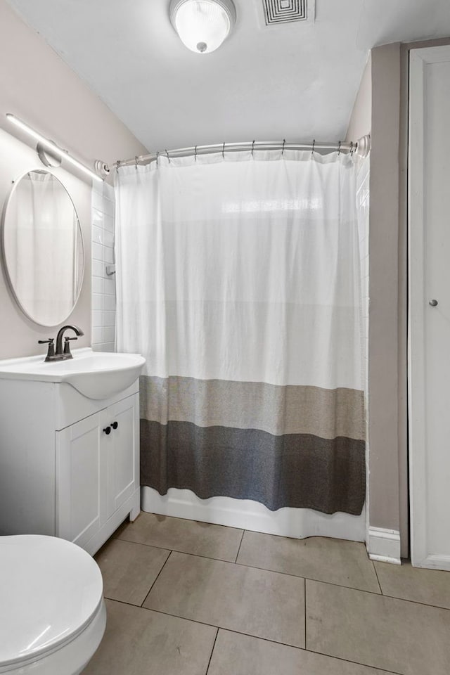 full bathroom featuring tile patterned flooring, vanity, shower / bathtub combination with curtain, and toilet